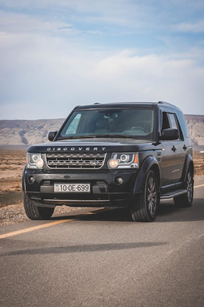 The land rover is driving on the road